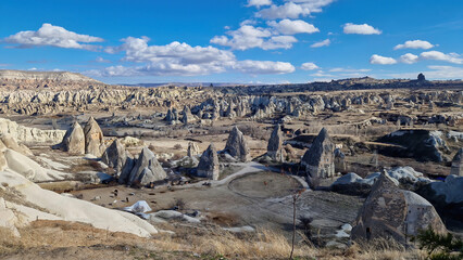 From the mountain's vantage point, Cappadocia unveils its pastoral heart: sprawling farms, patchwork fields, and the age-old rhythms of agrarian life echoing through time.