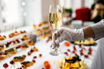 waiter hand hold champagne wine in glass