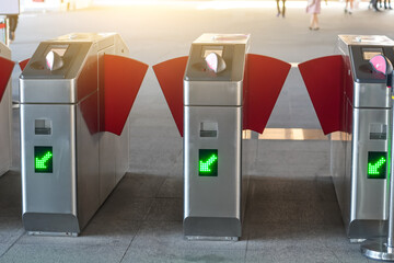 Modern train station entrance open gates entrance and exit with electronic card readers.