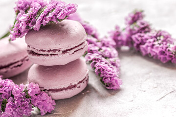 lady morning with macaroons and mauve flowers white desk background
