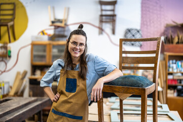 Portrait of a confident female carpenter standing in her workshop