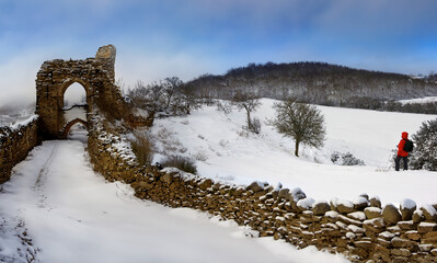 Snow covered landscape near the ruins of a castle in the Highlands of Scotland.