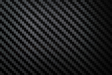 Carbon fiber composite raw material background. Carbon fiber texture. Dark Gray background with...