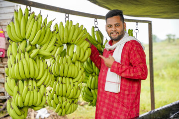 A man exporting banana branches while cutting them