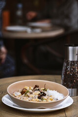 Pappardelle pasta with mushrooms and parmesan cheese on a plate . Traditional Italian gnocchi pasta with mushroom and parmesan cheese