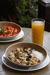 Pappardelle pasta with mushrooms and parmesan cheese on a plate . Traditional Italian gnocchi pasta with mushroom and parmesan cheese