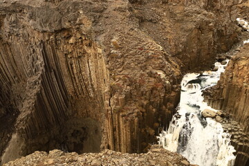 Stuðlagil is a ravine in Jökuldalur in the municipality of Múlaþing, in the Eastern Region of Iceland. It is known for its columnar basalt rock formations and the blue-green water that runs through it