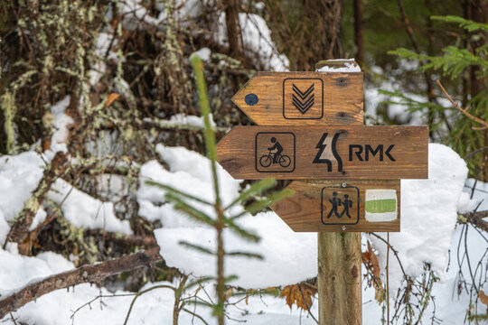 Hand-made wooden sign with directions RMK Estonian-Latvian border tourist trails