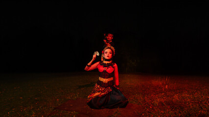 a group of female dancers with faces full of heavy emotional burdens sitting in the dark of night