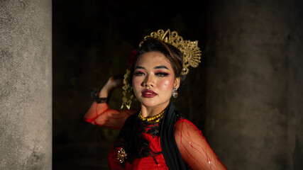 an Indonesian dancer with facial expressions that radiate beauty and happiness dances and...