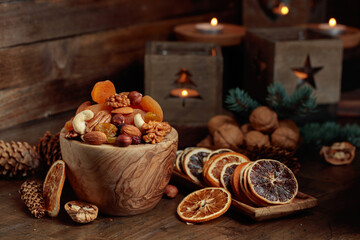 Dried fruits and assorted nuts on an old wooden table.
