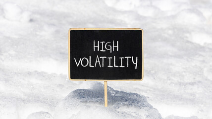 High volatility symbol. Concept words High volatility on beautiful black chalk blackboard. Chalkboard. Beautiful snow background. Business high volatility concept. Copy space.