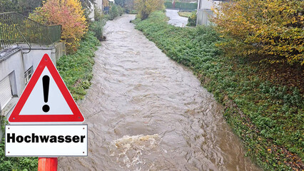Warning flood sign on a stream