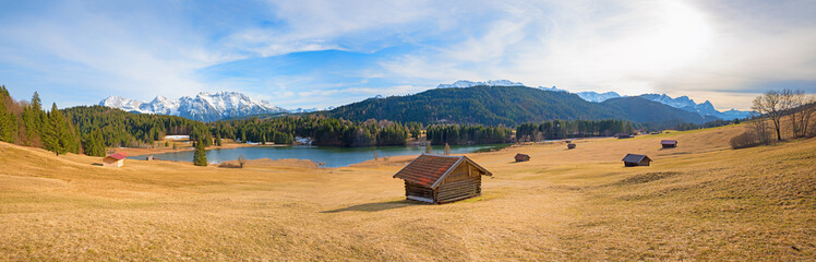 view over slope to lake Geroldsee and karwendel mountains in march