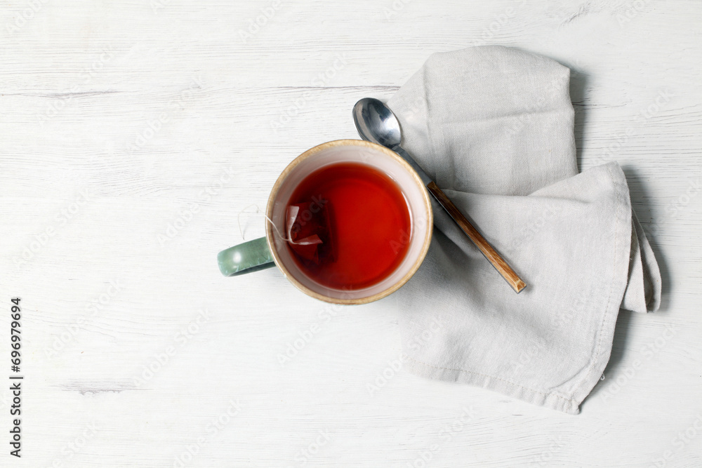 Wall mural cup of raspberry infusion on white background