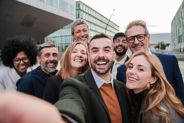 Big group of business people smiling taking a selfie portrait toguether. Crowd of business people...