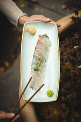 Sashimi on a dark background. Asian food. Service. Waiter. Banquet