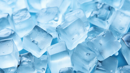 Top view of a pile of frosty frozen ice cubes on a blue background, refreshing, cold, ready for adding to a cold drink in a celebration or party or adding to a frozen fruit smoothie or blended dessert - obrazy, fototapety, plakaty