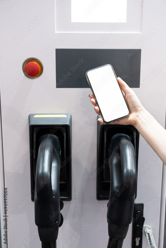 Poster hands with smartphone and charging plug on a background of electric car . white screen, you can add 