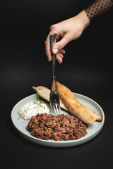 Appetizing veal tartare on a black background