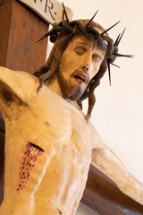 Deurstickers VICENZA, ITALY - NOVEMBER 7, 2023: The detail of medieval carved polychrome statue of Crucifixion in the church Chiesa di Santa Corona by unknown artist of 14. cent.  © Renáta Sedmáková