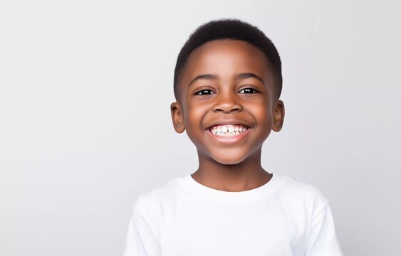 portrait of cute african boy model with perfect clean teeth laughing and smiling, studio photo, isolated white background