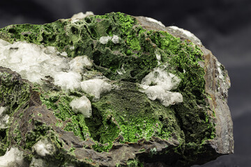 Close-Up of Vibrant Green Epidote Mineral Specimen on Dark Background
