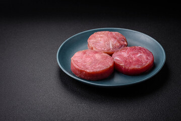 Round shape steaks of raw juicy tuna with salt and spices