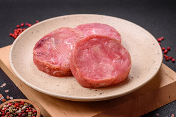 Round shape steaks of raw juicy tuna with salt and spices