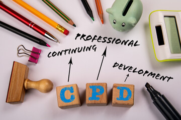 CPD - Continuing Professional Development. Wooden blocks on a white office table