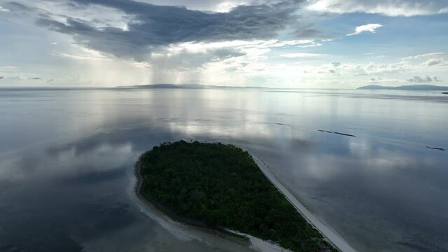 Early morning light illuminates the remote island of Koon near Seram, Indonesia. This scenic island's coral reefs, and the surrounding seas, support extraordinary marine biodiversity.