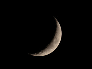 close up on waxing crescent moon on night sky