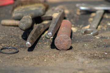 A pile of old tools on a wooden table