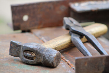 Hammer and pliers close-up, focus on the hammer