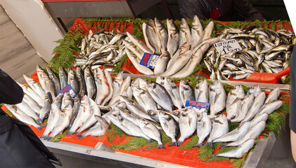 Woman buying fresh fish  in a Turkish bazaar