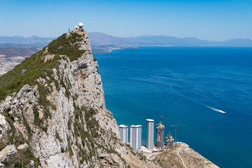 The top of the Rock of Gibraltar with the coastline and Alboran or Mediterranean sea in the background.