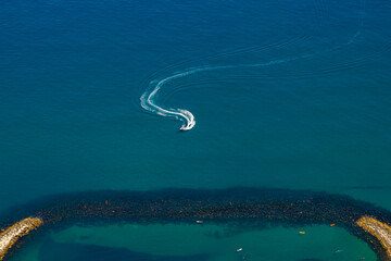 Boat sailing near the Sandy bay beach. View from the top of the Rock of Gibraltar