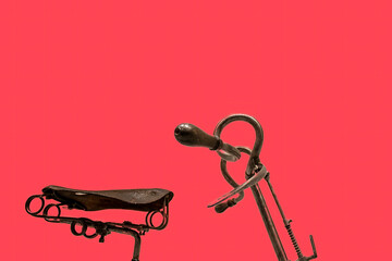 Bicycle seat and handlebars. Isolated on a red background. Copy space for text - obrazy, fototapety, plakaty