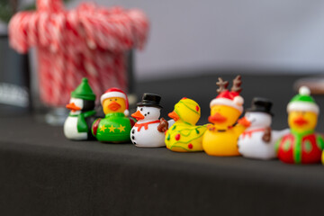 A row of small yellow and white rubber duckies with Christmas themes. Penguin, reindeer, Santa,...