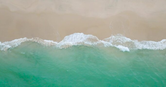Top-view Beach sea wave rolling come in sandy beach