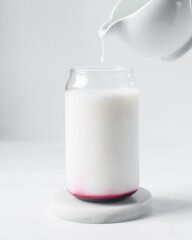 pouring milk into can shaped glass, skimmed milk in a glass shaped like a can, Aesthetic drink in a can glass