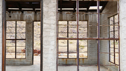 A skeletal, abandoned white building along the road to Indian Canyons.