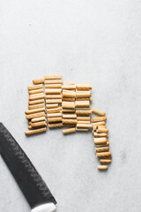 Chopped vanilla stick cookies on a marble countertop, stick cookies for dipping and baking