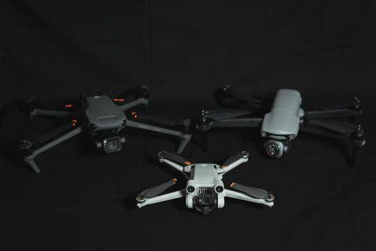 Estonia, Tallinn December 22, 2023. Modern drones with cameras for aerial photography and video. Dji mini 3 pro and mavic 3 classic, autel evo lite plus on the table.