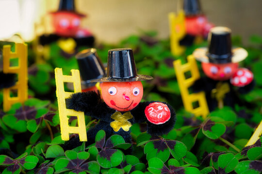 funny chimney sweep dolls on shamrocks as new year's decorations
