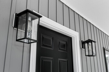 Farmhouse Modern Black Front Door with Matching Outdoor Lantern-Style Lights