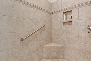 Spacious Tiled Walk-In Shower with Built-In Bench, Safety Grab Bar, and Recessed Shelf in a...