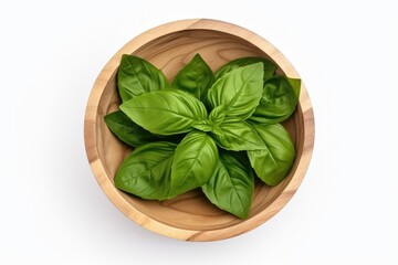Top view of a single fresh basil leaf in a wooden bowl, isolated on a white background and with a full depth of field.