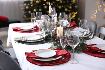 Christmas table setting with festive decor and dishware indoors