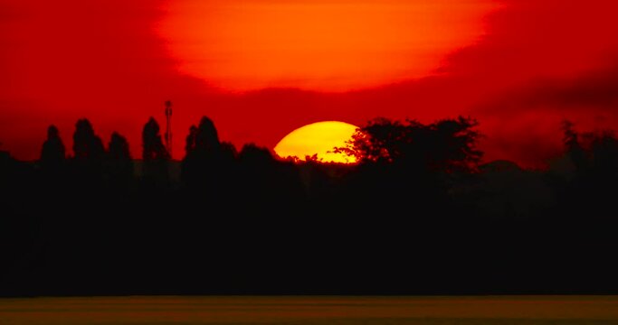 Big Sunrise Timelapse video Close-up the sun in red cloud sky over horizontal.ProRes422